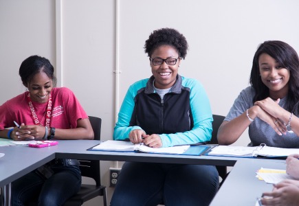 Three women smiling during SI