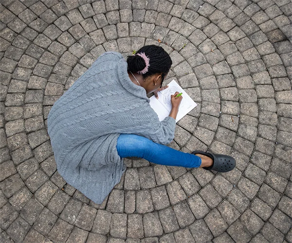 student drawing on pavement
