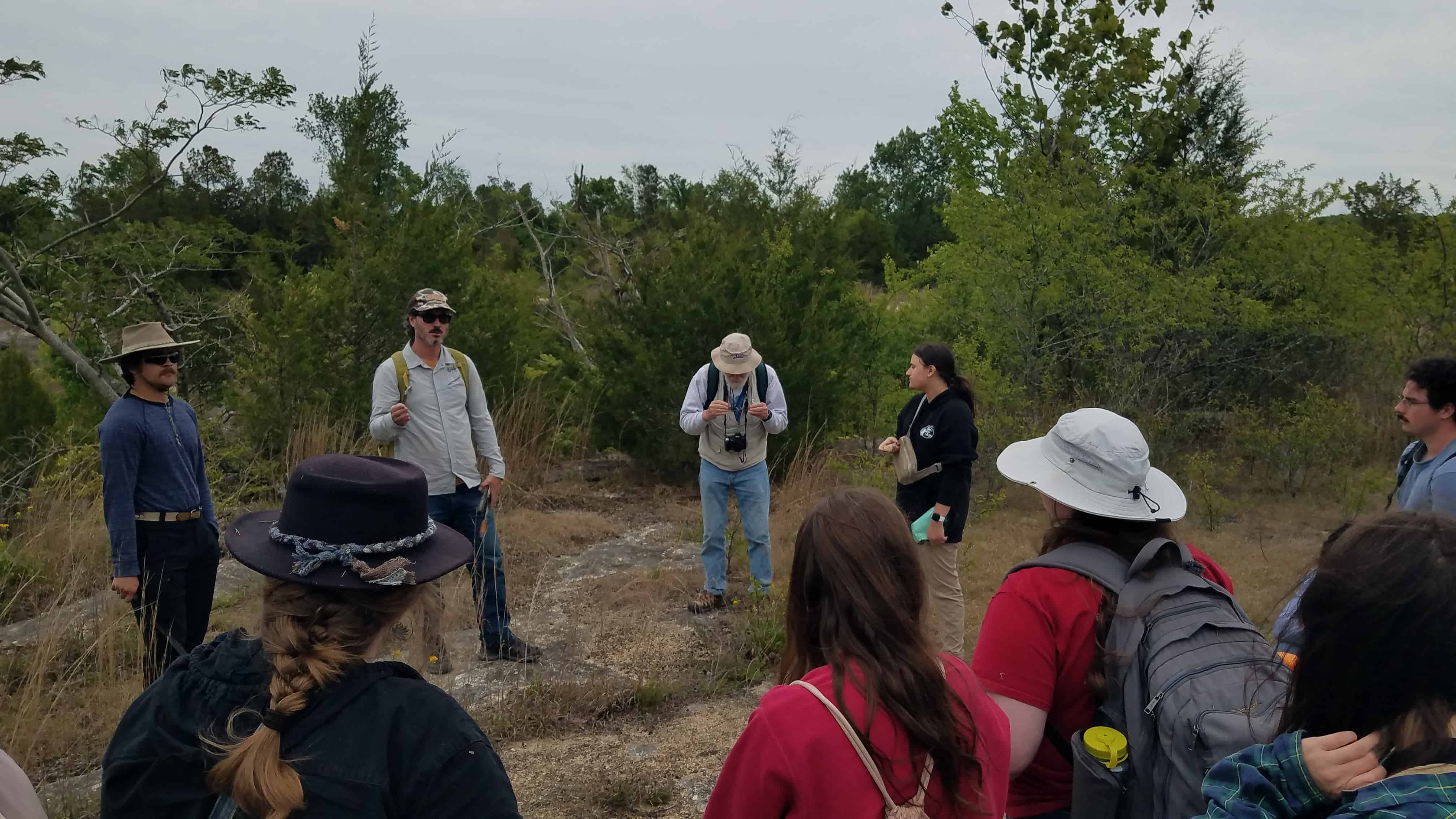 Dr. Cody Mason leads students through hands-on field exploration, fostering discussion, observation, and critical thinking in a real-world learning environment.