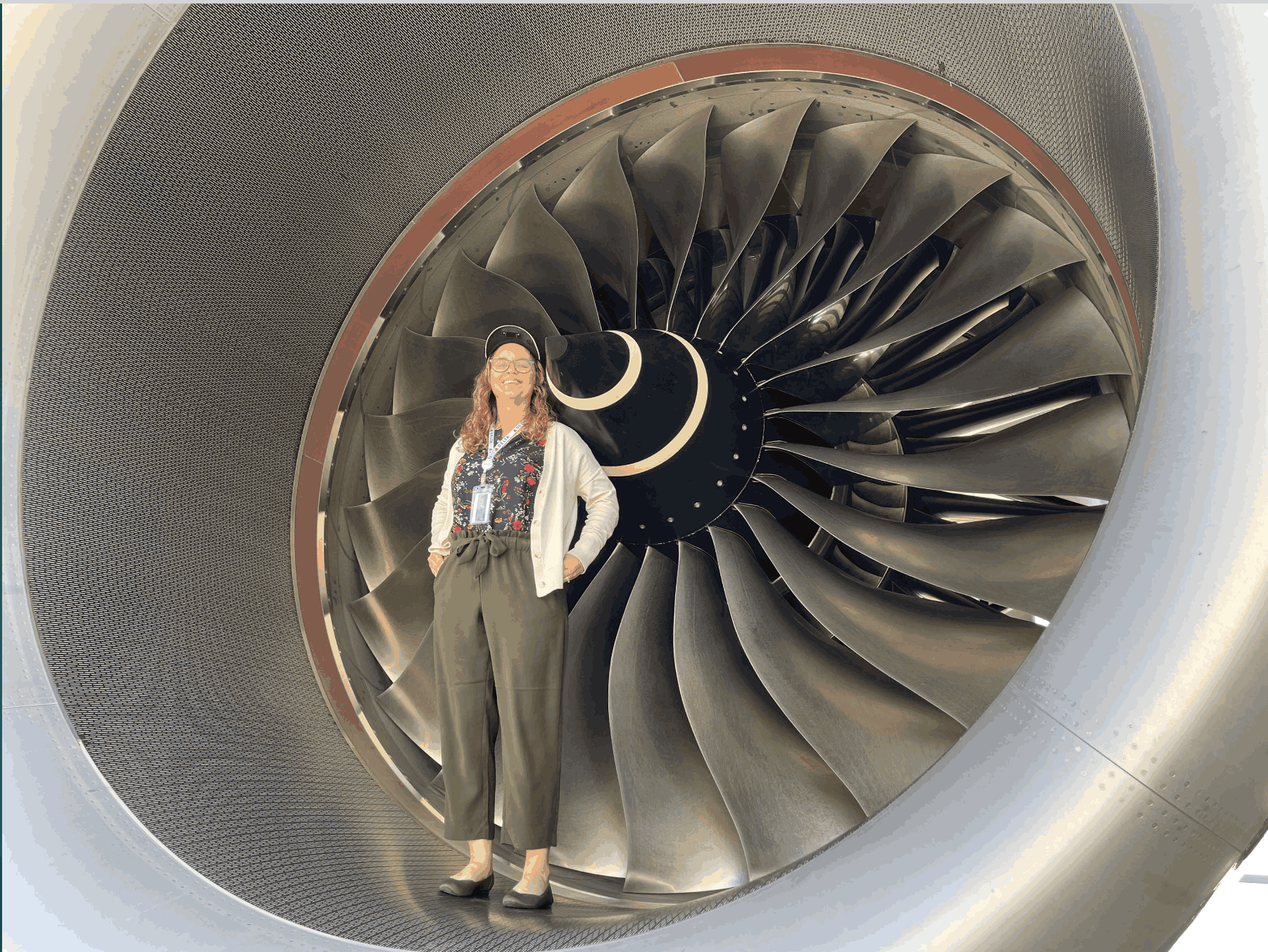 Students standing in front of airplane engine