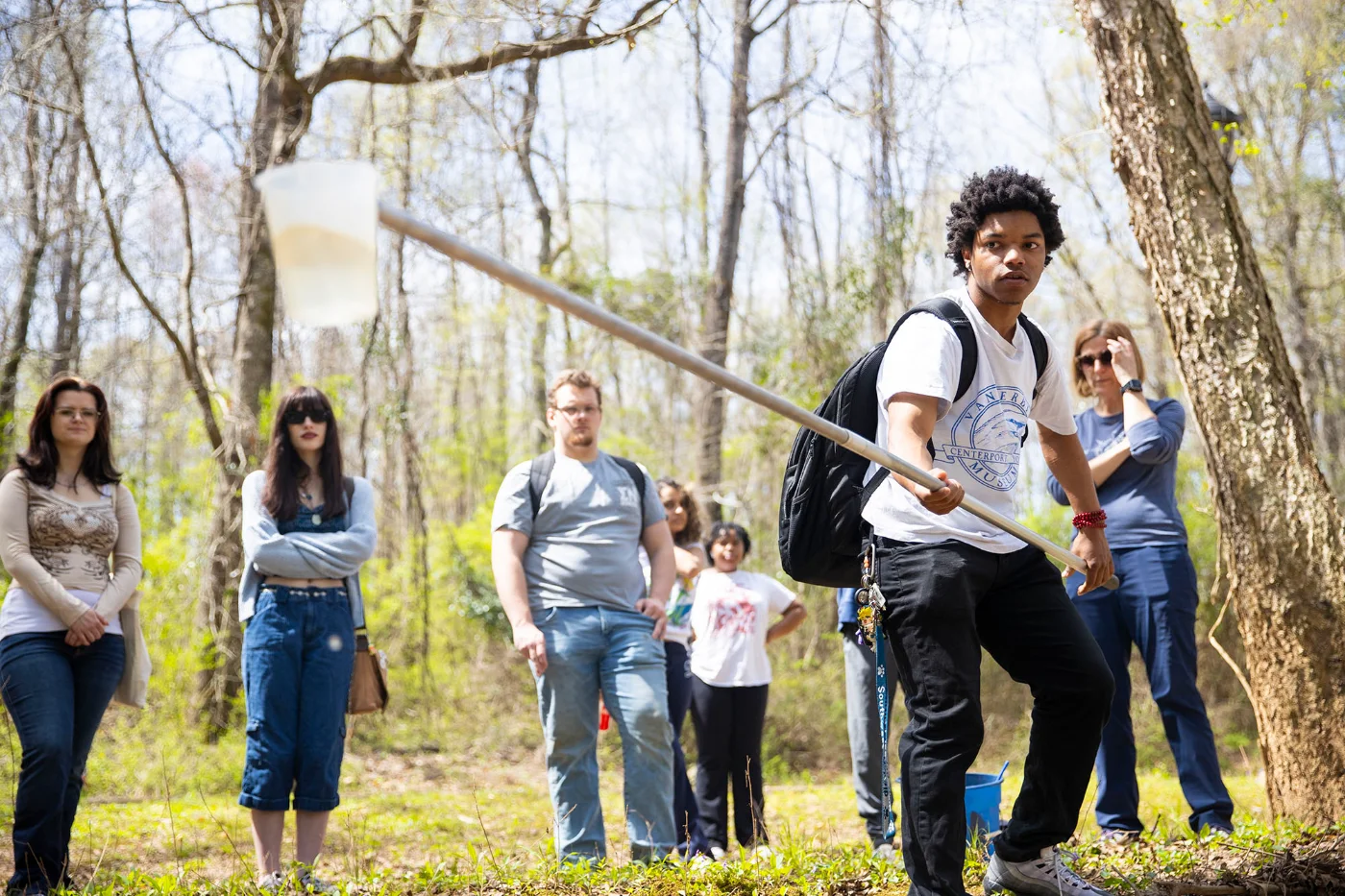 students taking water samples from creek
