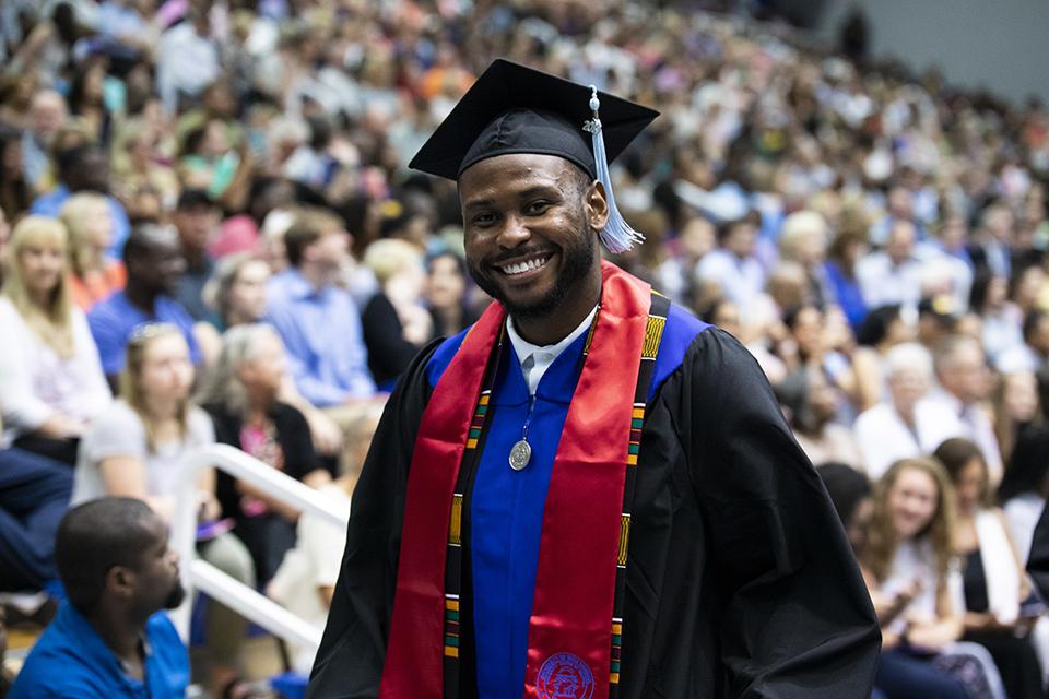 student preparing to walk across the graduation stage.