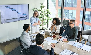 People sitting around conference table having a conversation.