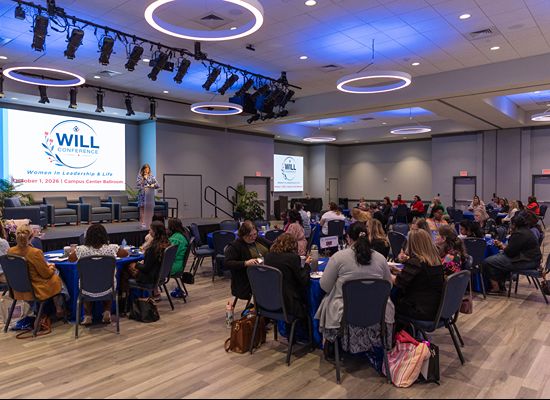 Female presenter address conference participants at the WILL Spring 2026 Conference in the Campus Center.