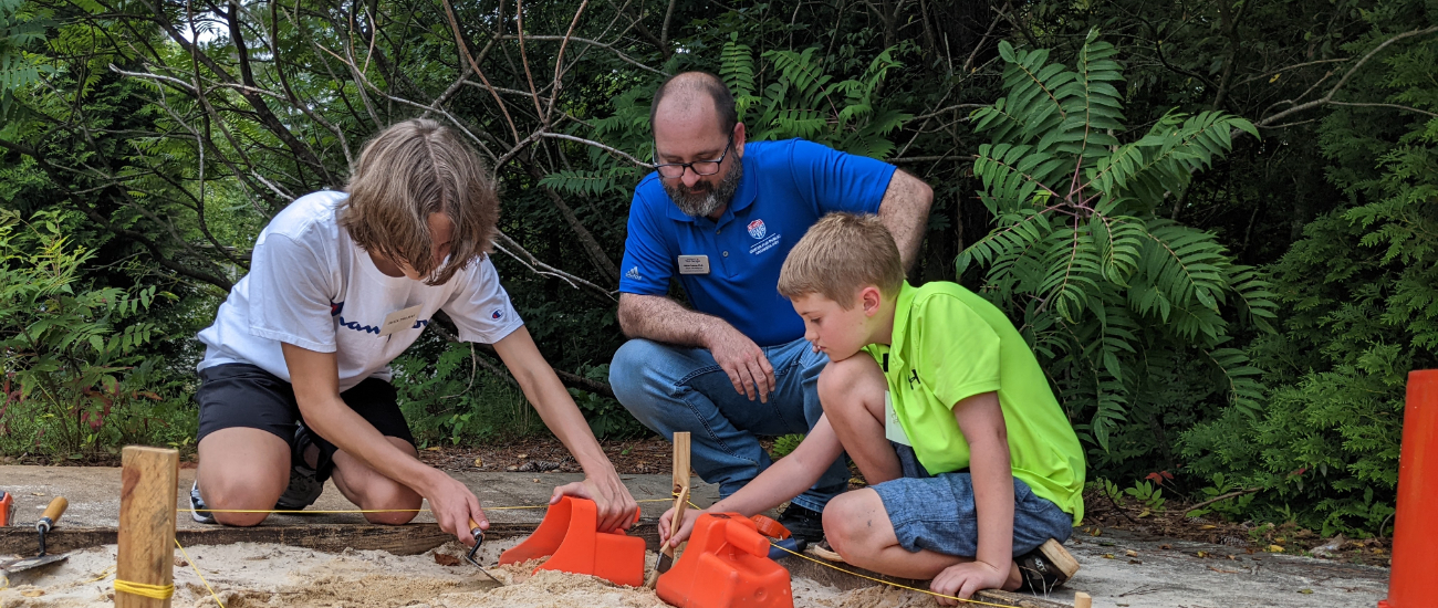 instructor with the archaeology campers