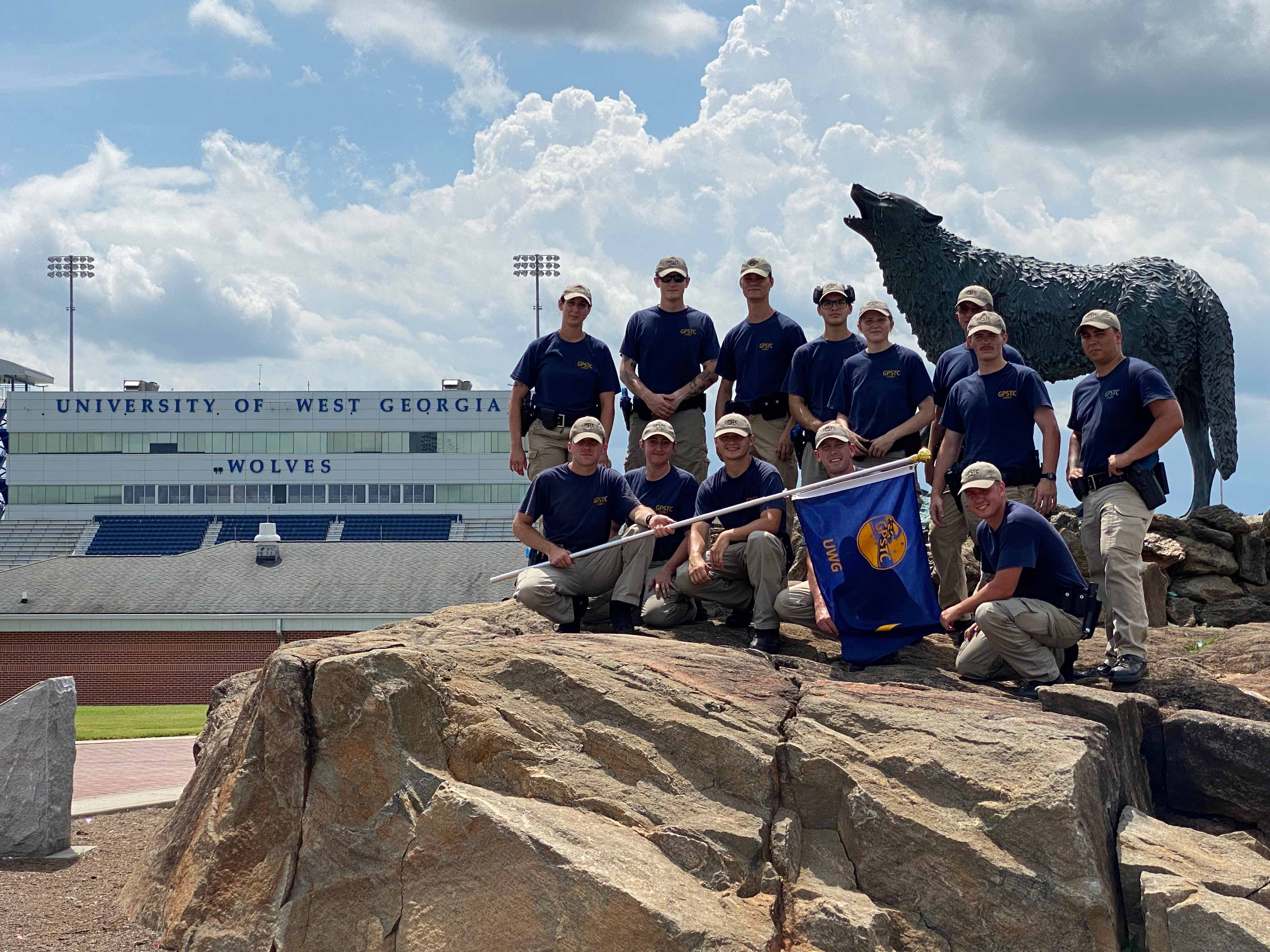 The first cohort of the ALETE program in front of the wolf at the Stadium