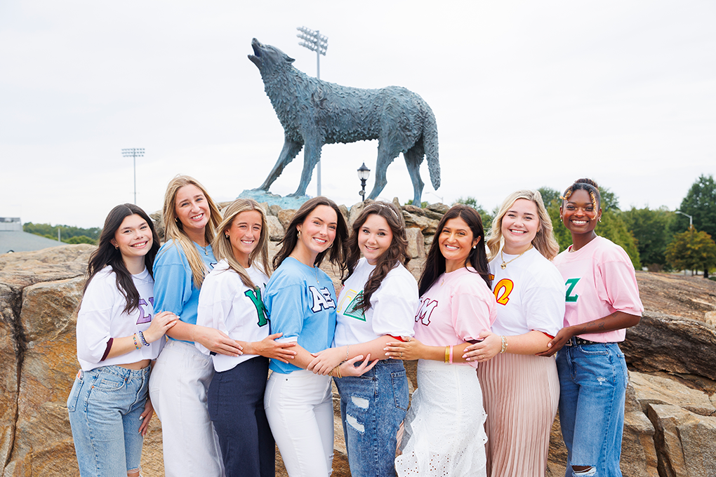 CPC students in front of wolf statue