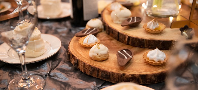 Small fancy desserts on a nice wood platter