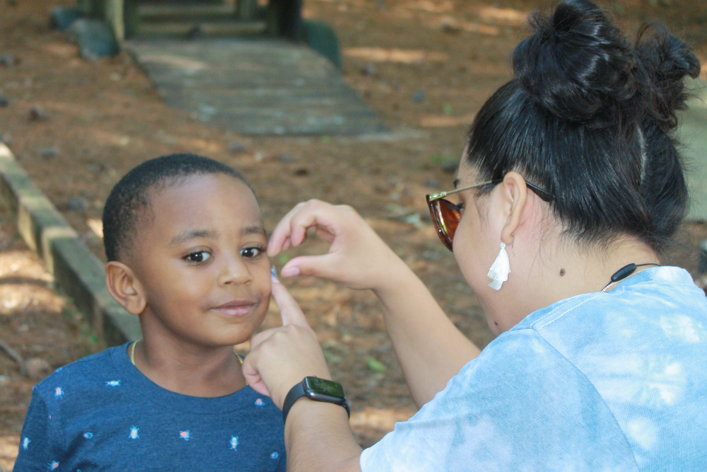 Pre-K student getting a spirit day sticker.