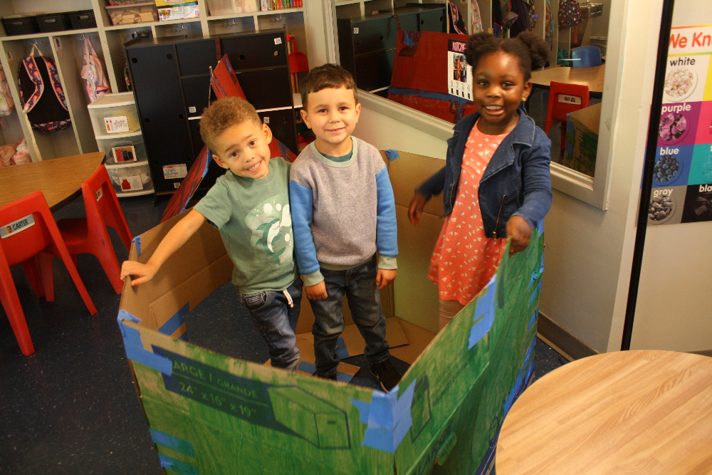 Pre-K students working on a makerspace activity together.