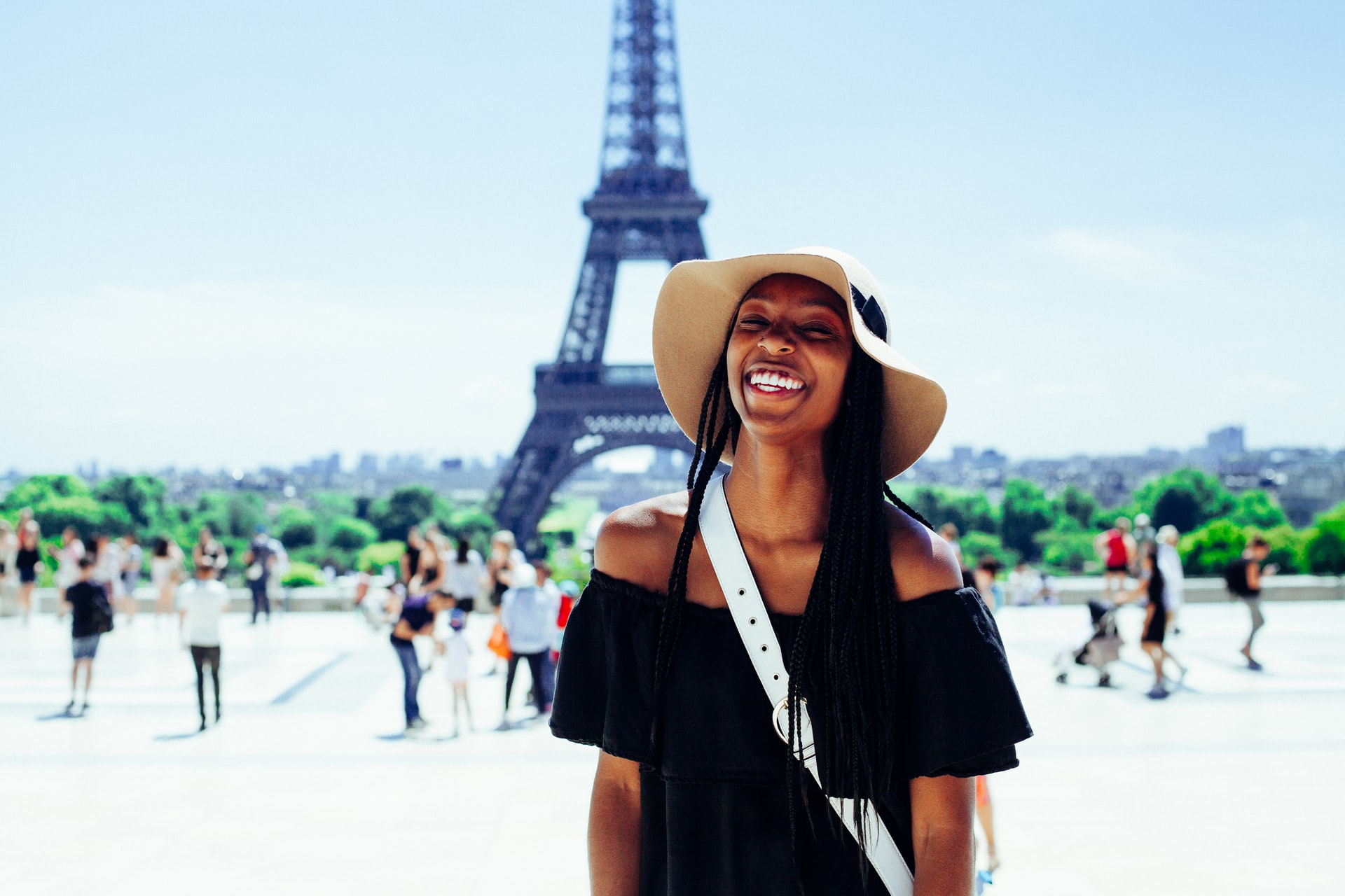 female smiling with the Eiffel Tower in the distance