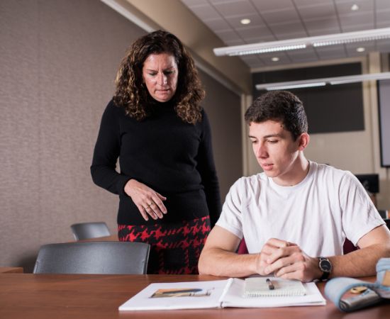 Teacher helping college student