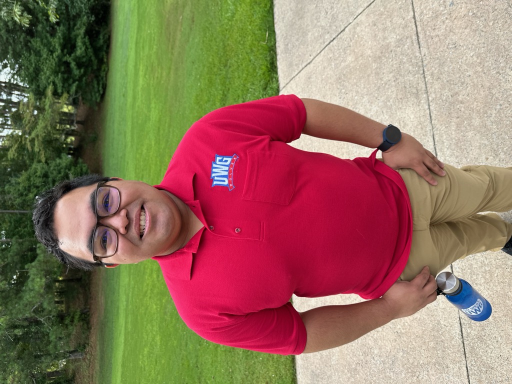 profile picture of Dr. David Miranda in a red shirt with a green field in the background.