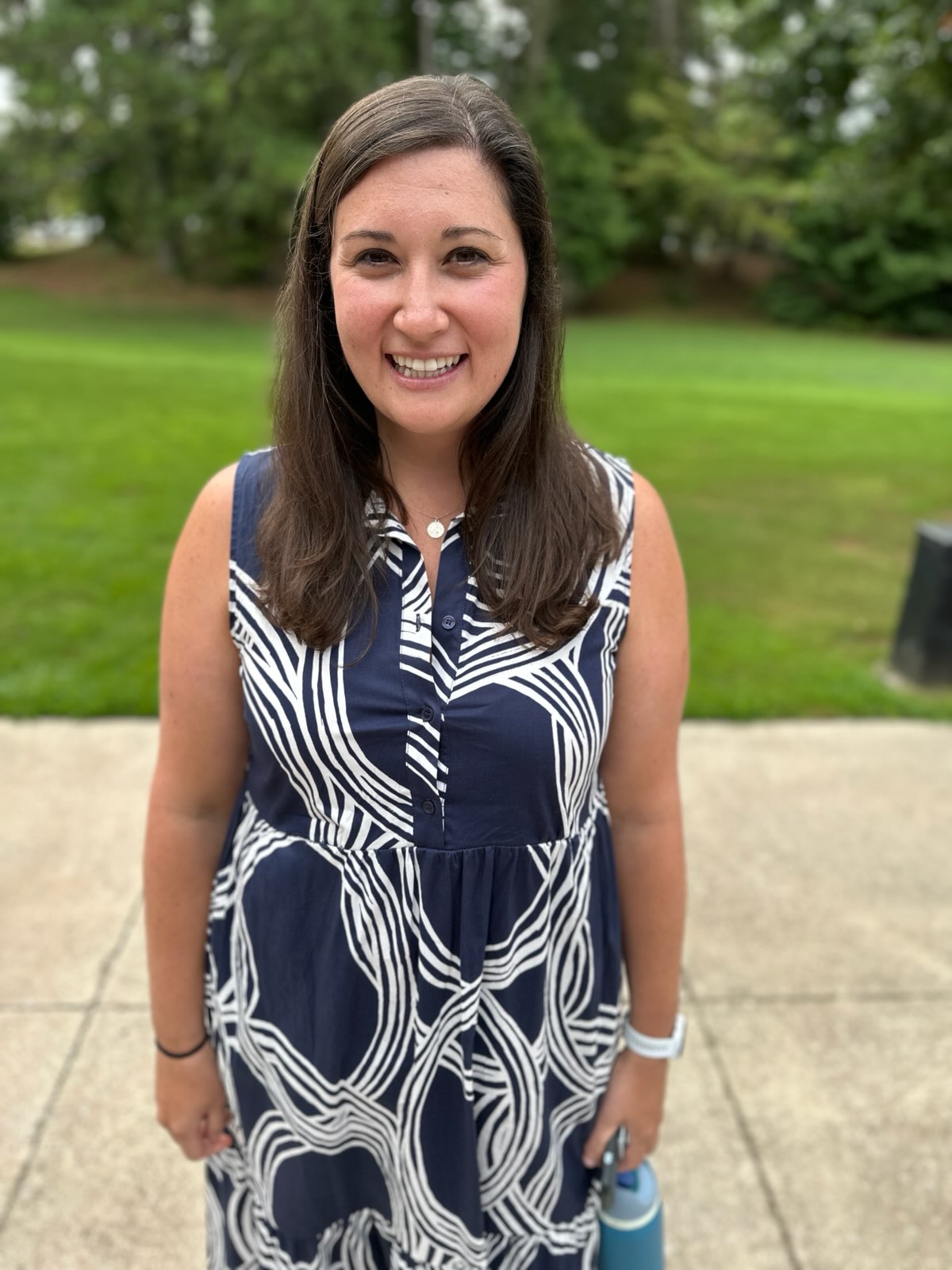 profile picture of Dr. Marney Dzialo in a blue dress with a field in the background.