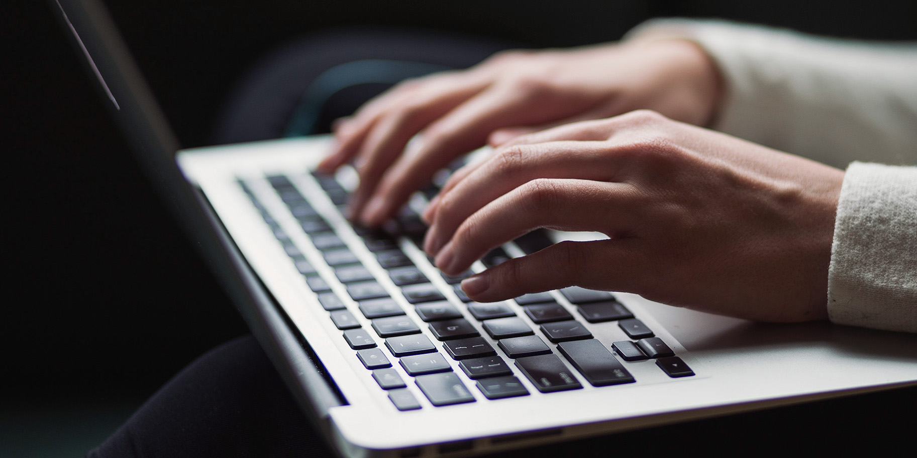 person typing on laptop