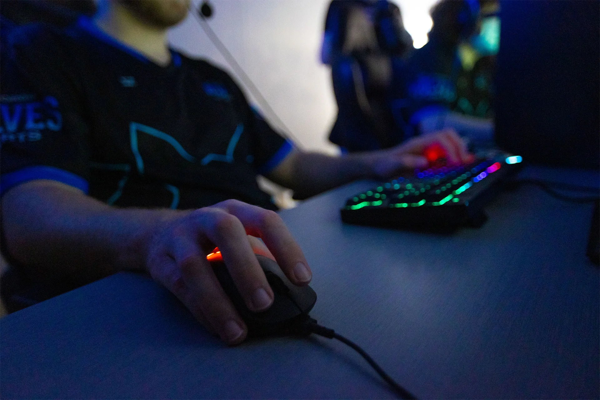 Close up of eSports players hands on gaming keyboard and mouse.