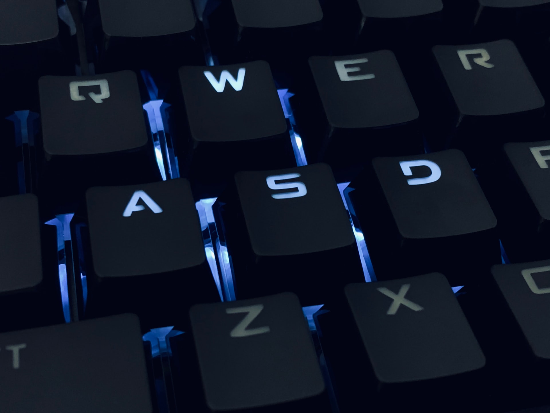 close-up photo of the W, A, S, and D keys on a gaming keyboard.