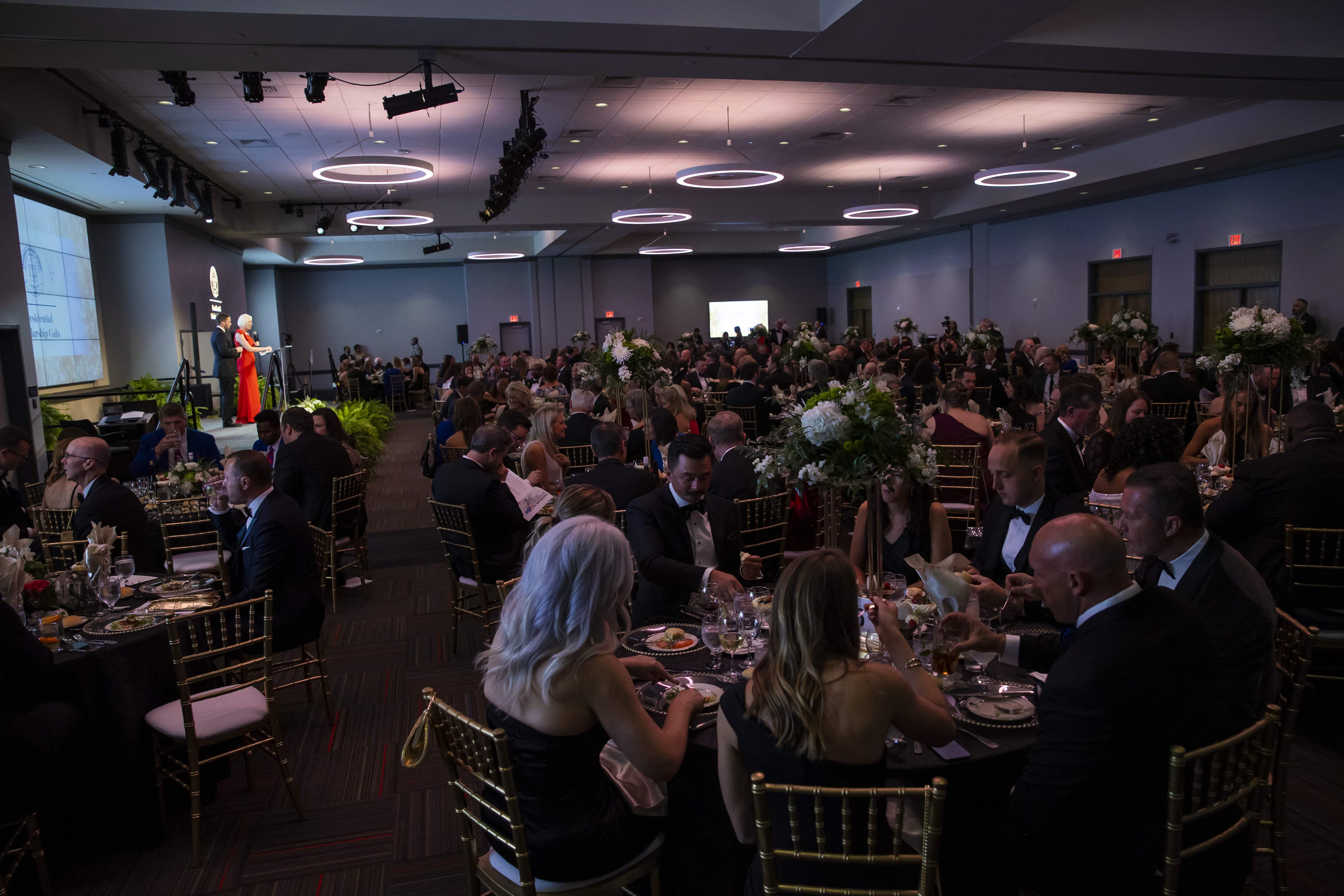 Past years Gala showing attendees sitting at tables dressed in formal attire.