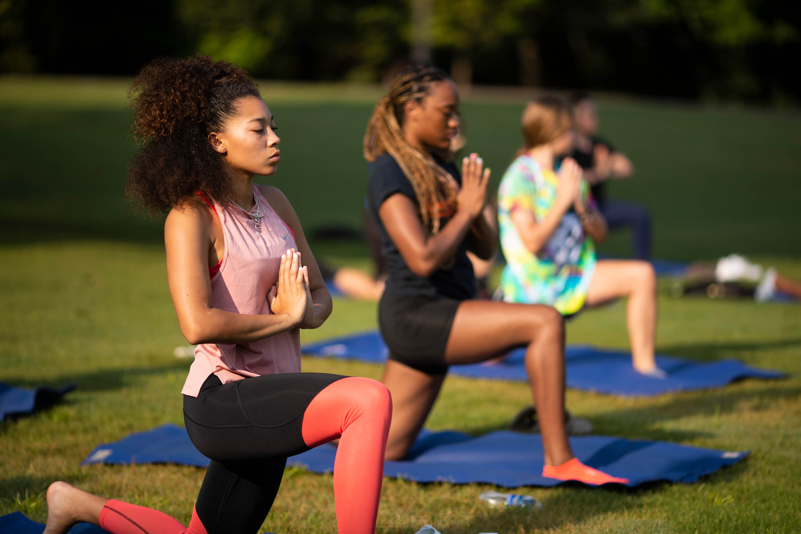 Students doing yoga outside