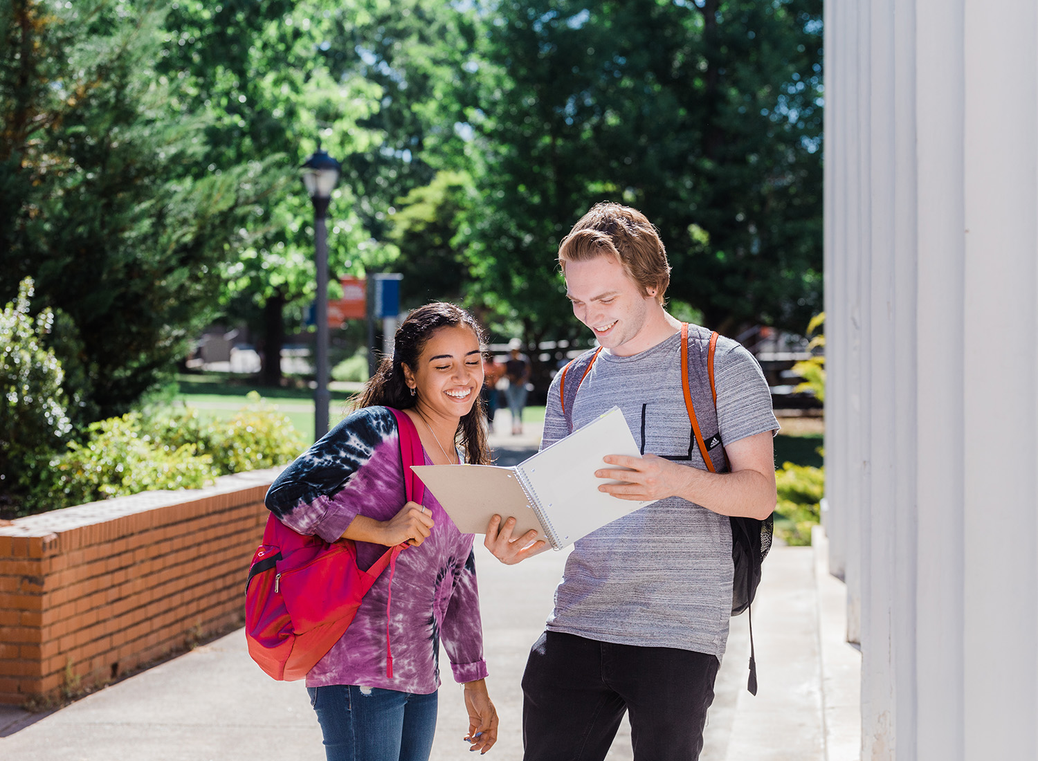 Two students walking on campus