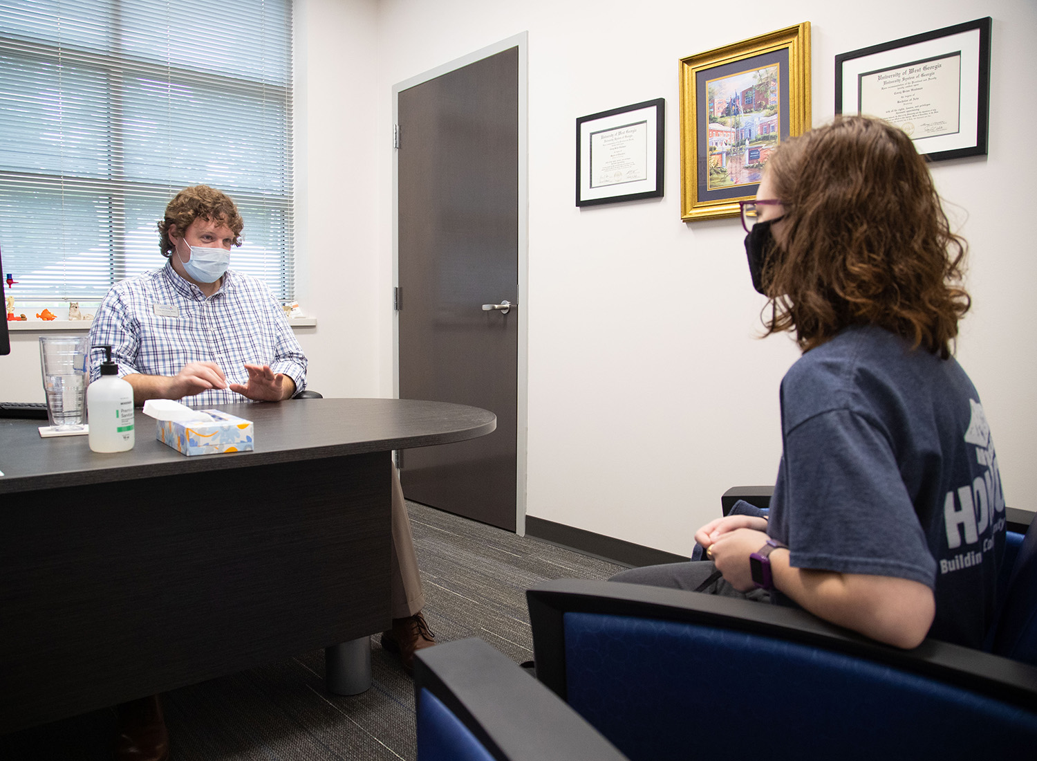 Advocacy staff conversing with a student patient