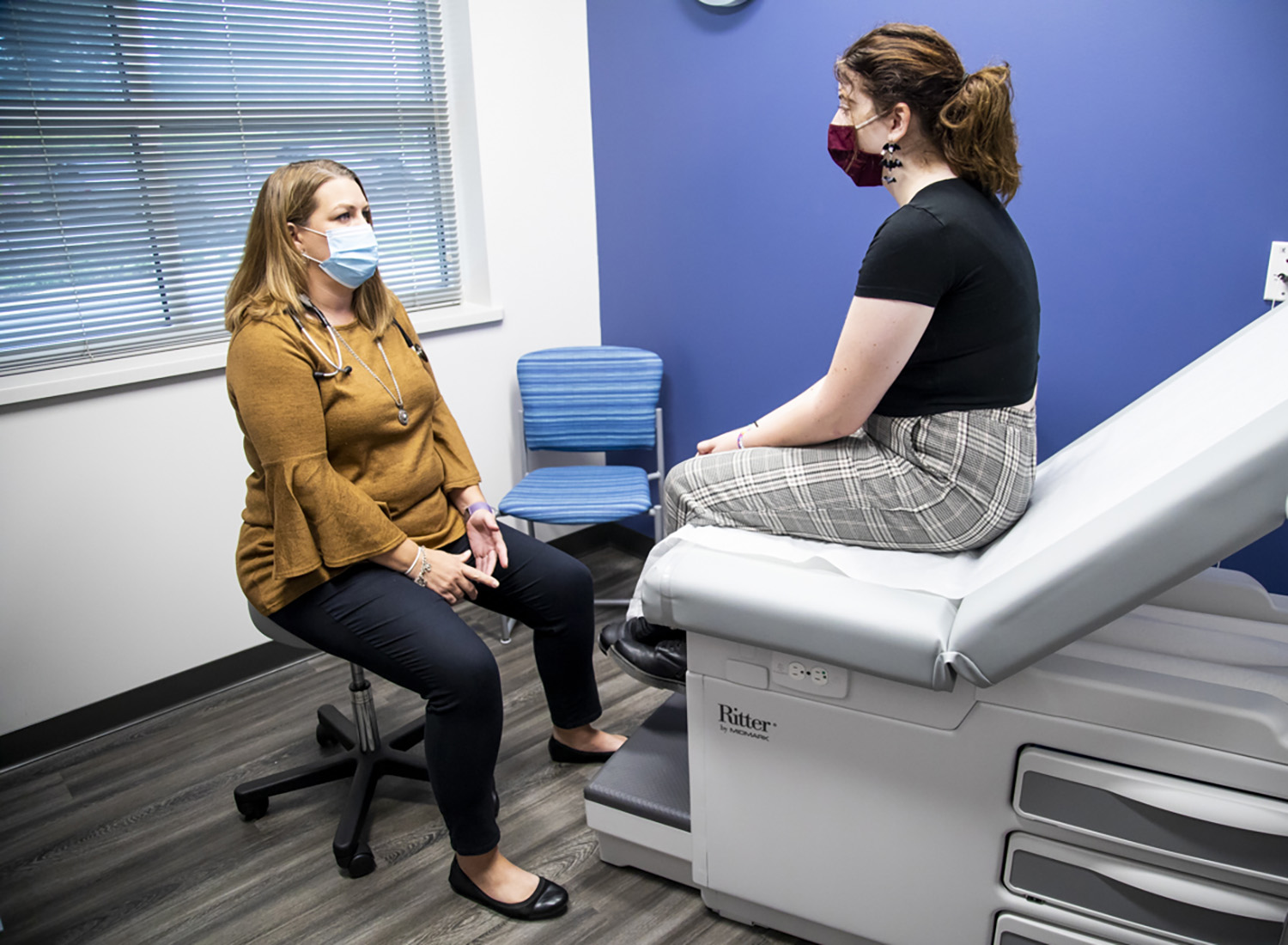 student conversing with health services staff