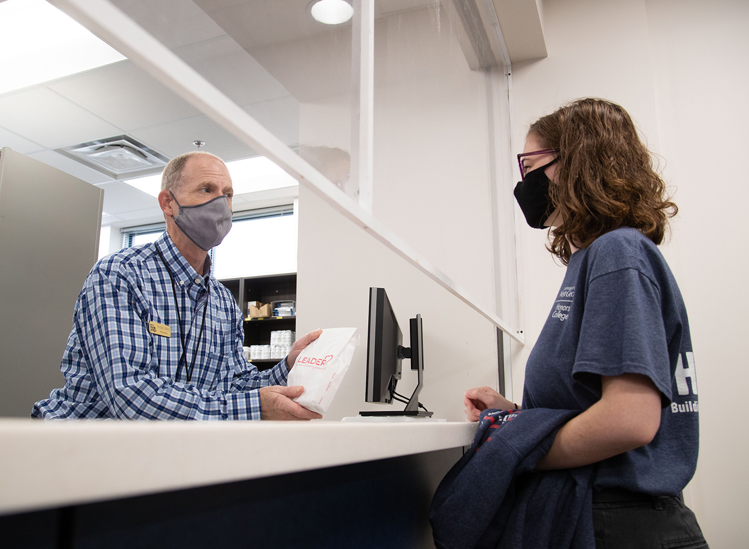 pharmacy staff discussing medication with a student