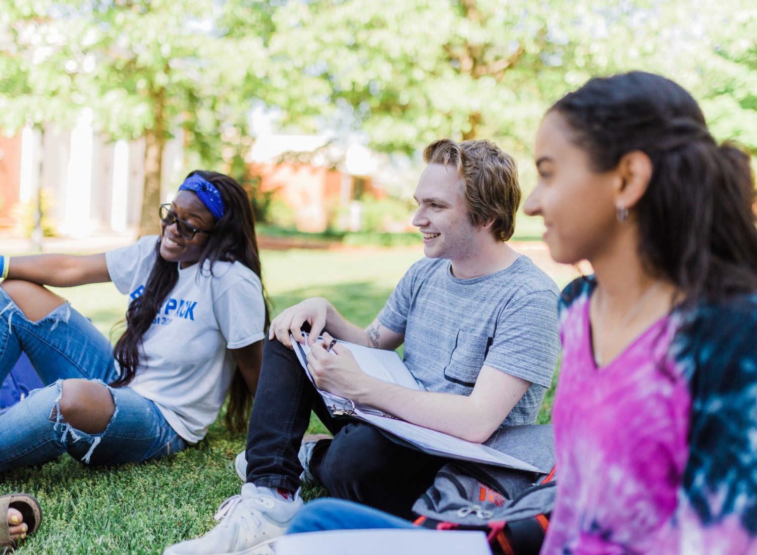 Students smiling and studying outside.