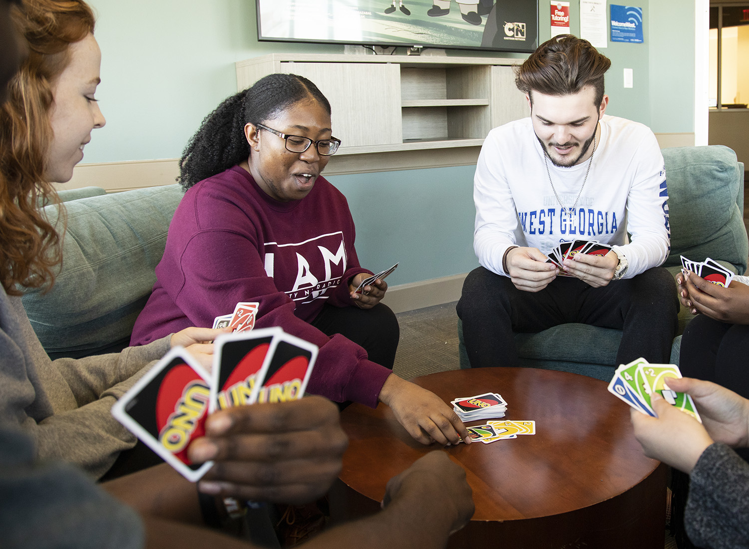 students playing Uno in a residence hall common area