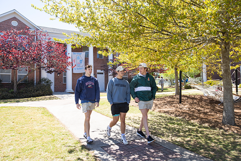 Students walking outside of village 