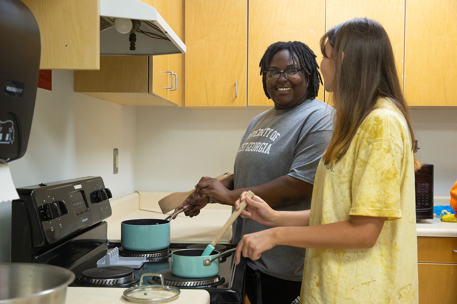 two students cooking together