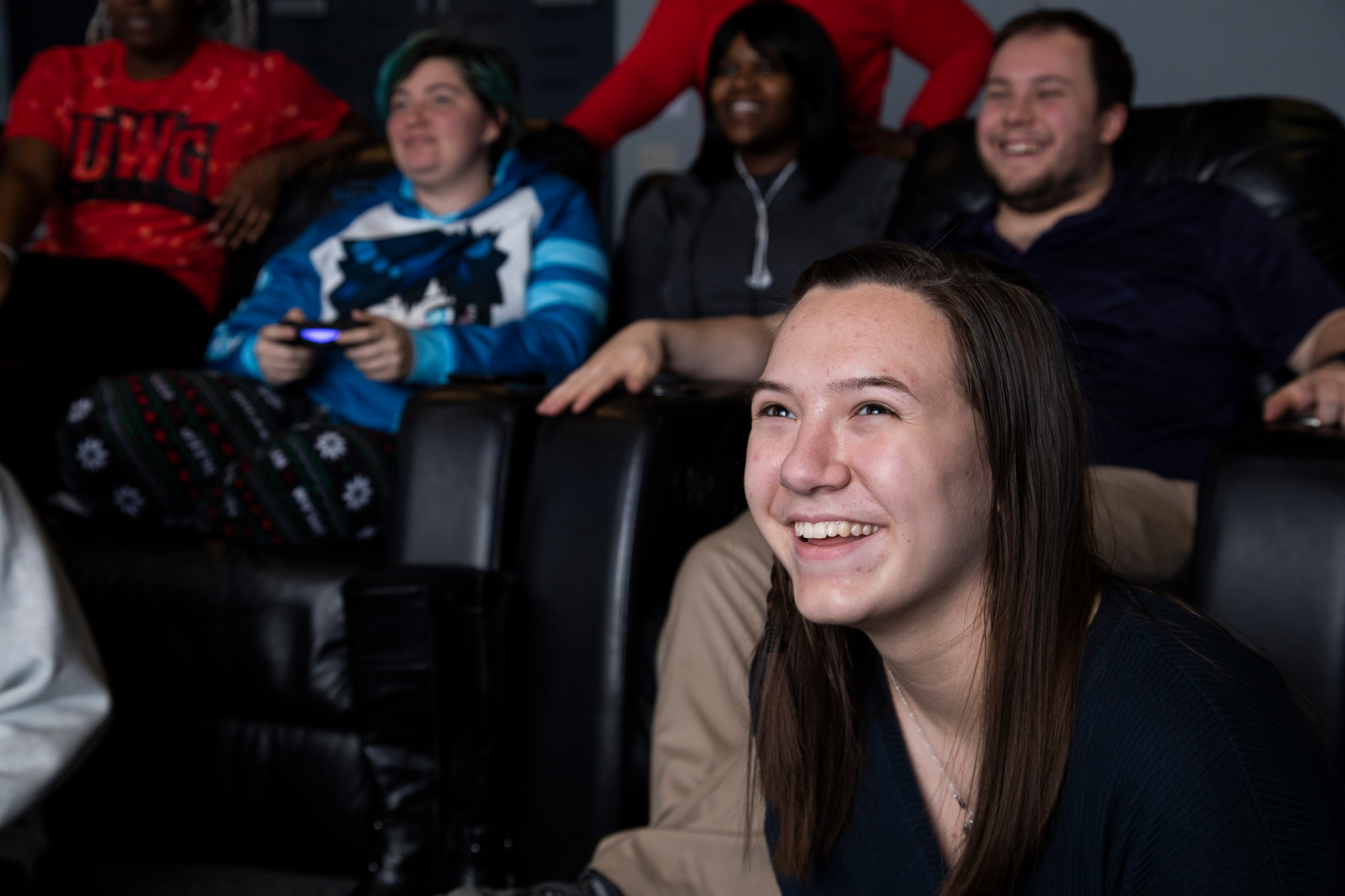 Students watching a movie together in the housing movie theater