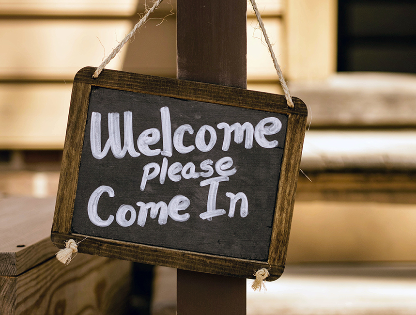 Chalkboard with the phrase welcome please come in written on it