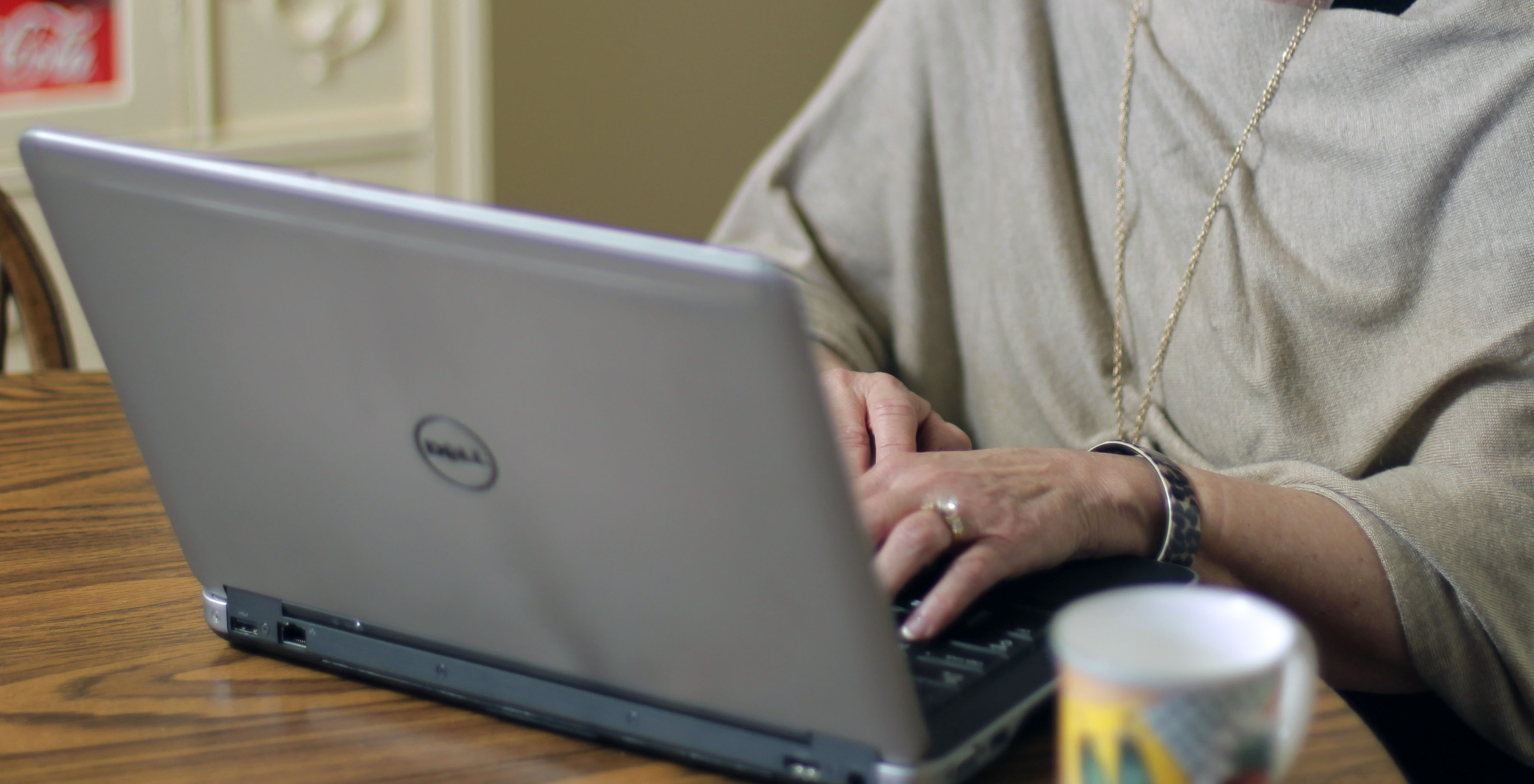 Working on a laptop with a cup of coffee