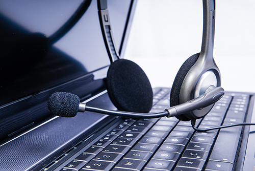 Headset sitting on laptop keyboard.