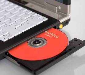 Loading red software CD into laptop.