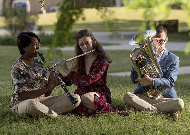 students playing instruments on grass