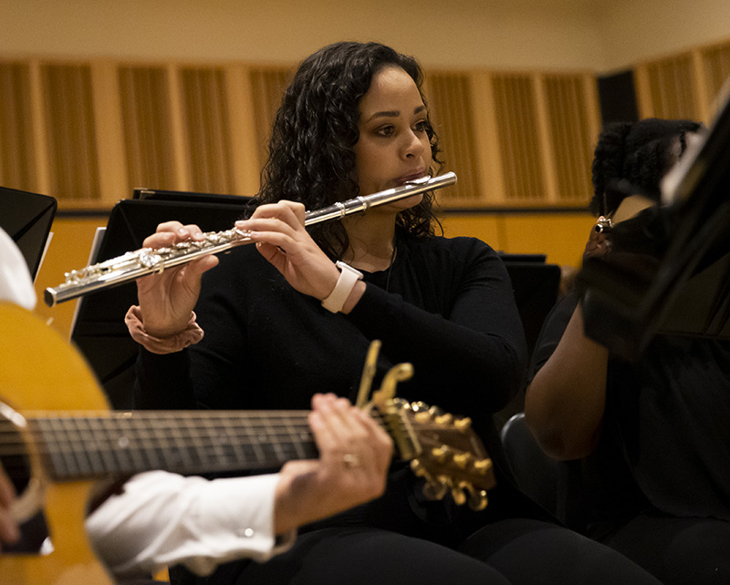 students playing flute and guitar in wind ensemble