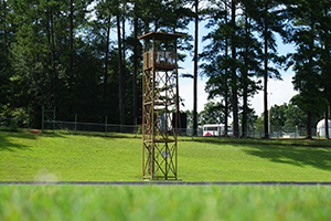 Marching band tower standing tall at edge of field.