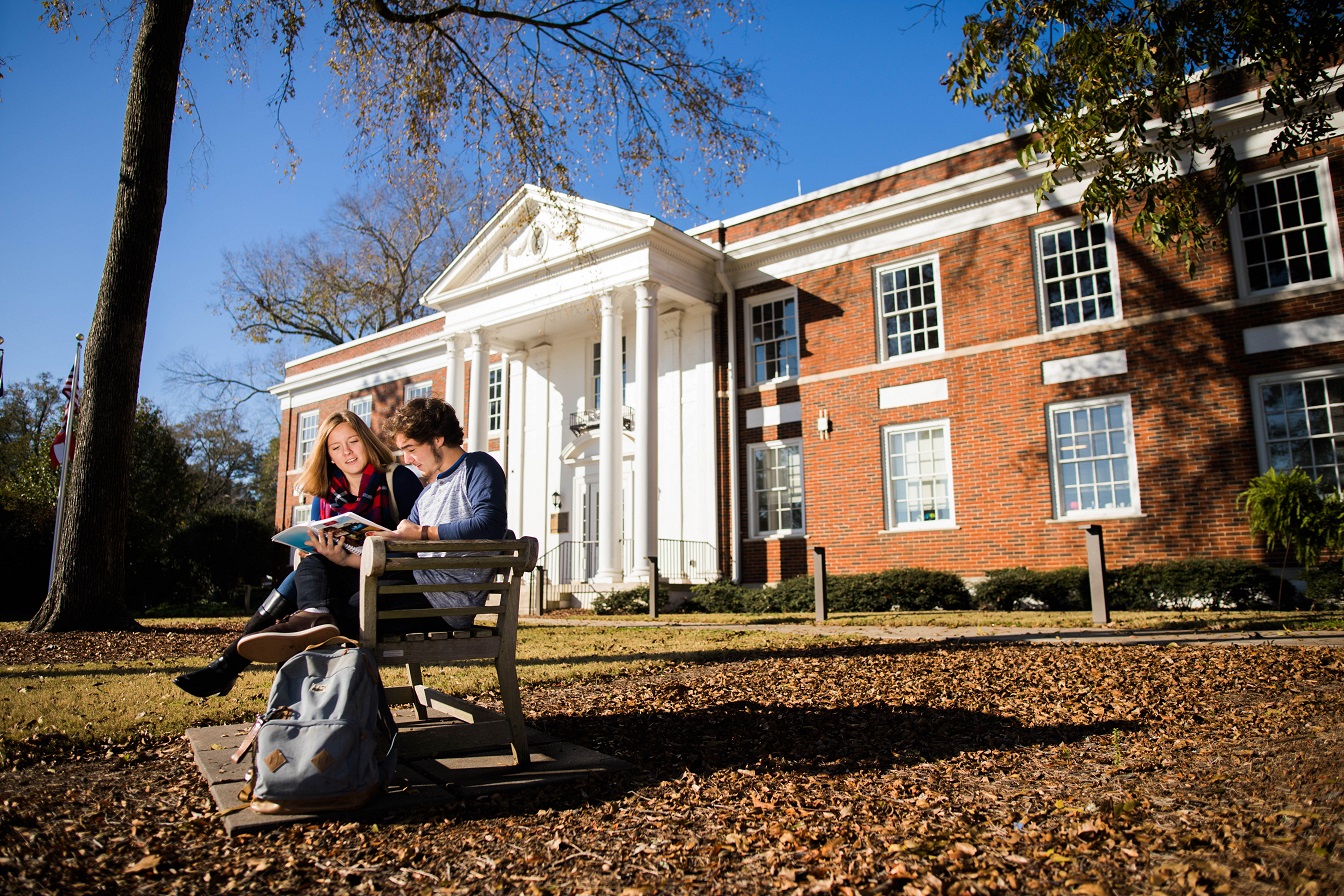 Student reading on bench at Newnan