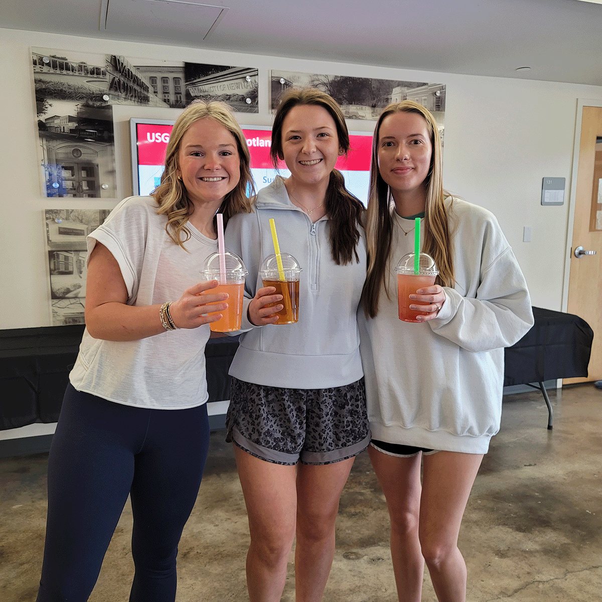 Three students holding fizzy drinks from the Bubbly Tuesday Event