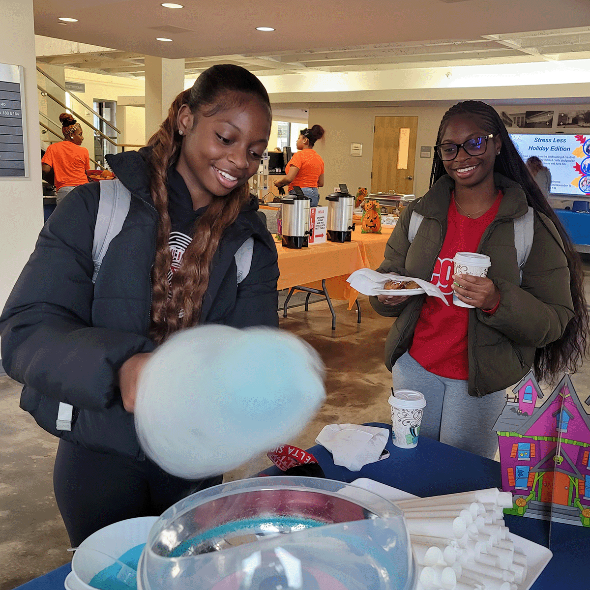 Students making cotton candy and eating food at the safe treats and s'mores event in Newnan