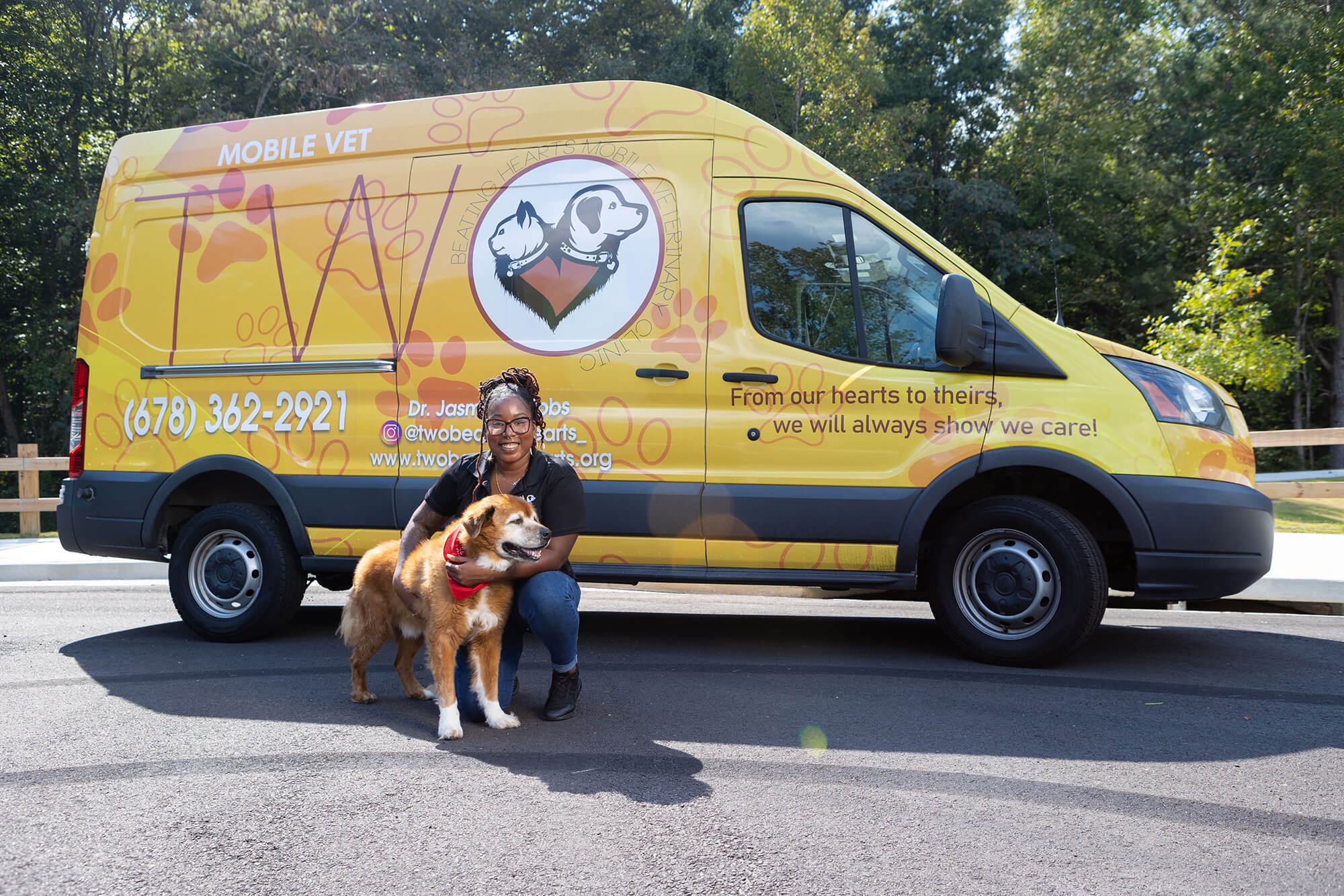 Dr. Jasmine Gibbs and her dog, Spike, outside the Two Beating Hearts Mobile Veterinary Clinic