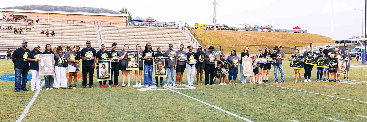 The McDaniels and other families gather at UWG's University Stadium during Childhood Cancer Awareness Month.