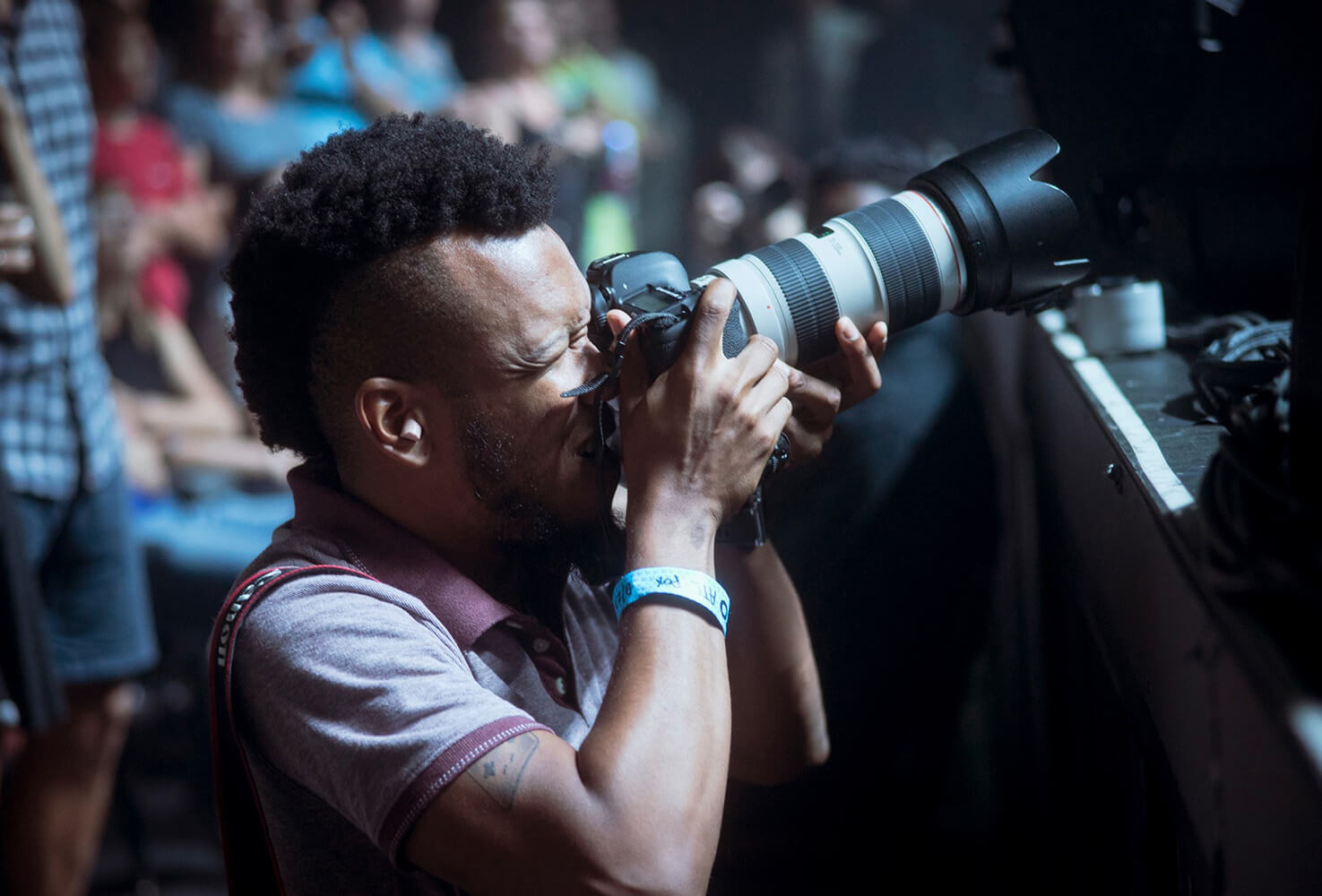 UWG alumnus Terence Rushin holding a camera, photographing a concert