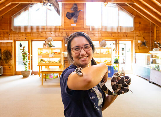 UWG alumna Joanne Wasdin holding a snake