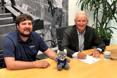 Albion Executive Vice President, Brian Newsome (right), signs off on an endowed scholarship for the University of West Georgia with Jason Strane, project manager.