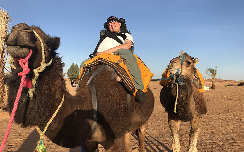 Cory Lee Woodard on a camel in Sahara Desert, Morocco