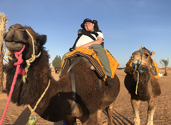 Cory Lee Woodard on a camel in the Sahara