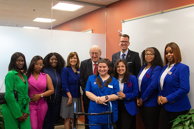 Dean of UWG's Tanner Health System School of Nursing Dr. Jenny Schuessler, Herb Hatton, and UWG President Dr. Brendan Kelly recently gathered with nursing students.